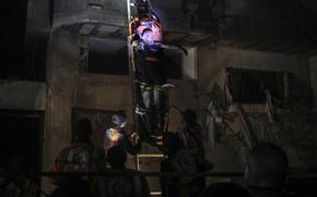 Palestinian civil defence members evacuate survivors of the Israeli bombardment on a residential building of Abu Alenan family in Rafah, southern Gaza Strip, early Saturday, May 4, 2024. (AP Photo/Ismael Abu Dayyah)