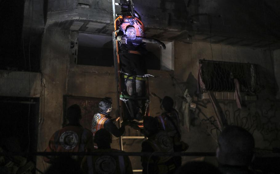 Palestinian civil defence members evacuate survivors of the Israeli bombardment on a residential building of Abu Alenan family in Rafah, southern Gaza Strip, early Saturday, May 4, 2024. 