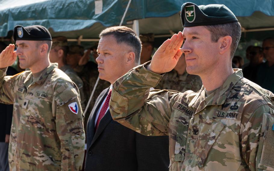 Col. Reid E. Furman, right, the new commander of U.S. Army Garrison Rheinland-Pfalz, stands with Tommy Mize, director of Installation Management Command  Europe, and Lt. Col. Jeremy McHugh, commander of Army Support Activity  Black Sea, at a change-of-command ceremony in Kaiserslautern, Germany, on Friday, July 22, 2022.