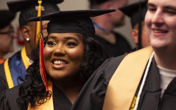 A graduate prepares to walk the stage to receive her degree
