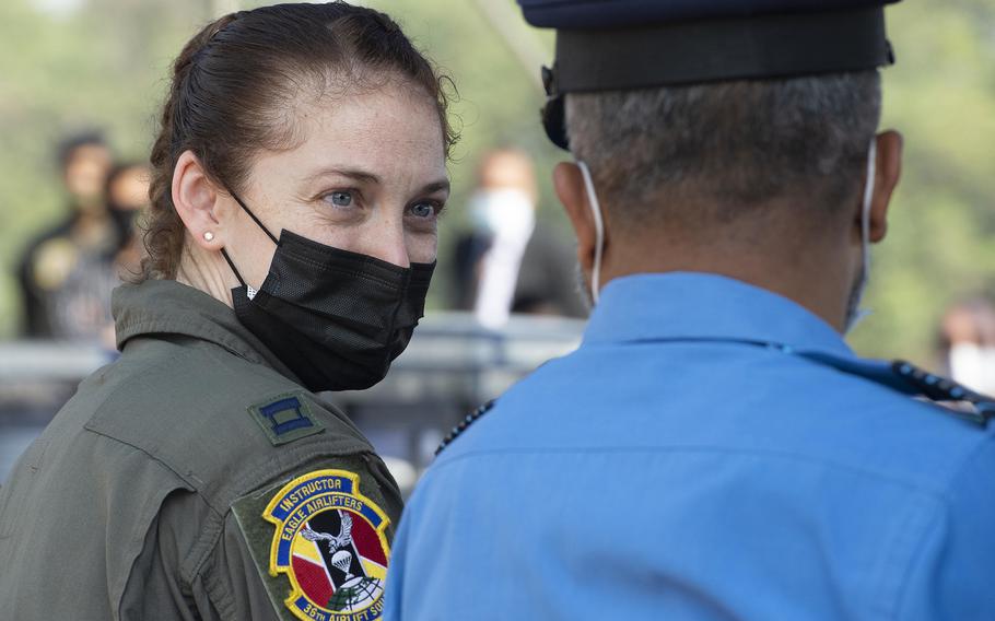 Air Force Capt. Madeline Atkinson of the 36th Expeditionary Airlift Squadron speaks with a Bangladesh Air Force officer during the Exercise Cope South 2022 opening ceremony at BAF Base Bangabandhu, Bangladesh, on  Feb. 19, 2022. 