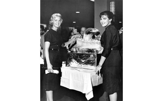 Okinawa, Japan, Sep. 11, 1960: Beverly Beeler (left), Kubasaki Junior High School, and Dotty Breslar, Sukiran Elementary School, help themselves to hors d’oeuvres at a welcome party Sunday for Okinawa’s new teachers. The Central Parent Teachers Assn. of Okinawa greeted some 180 new educators at a party in the Castle Terrace Club at Camp Kue.

Looking for Stars and Stripes’ historic coverage? Subscribe to Stars and Stripes’ historic newspaper archive! We have digitized our 1948-1999 European and Pacific editions, as well as several of our WWII editions and made them available online through https://starsandstripes.newspaperarchive.com/

META TAGS: Pacific; DoDEA; DODDS; school; education; dependents; civilians; Central Parent Teacher Association; PTA; parents; military life; ice sculpture