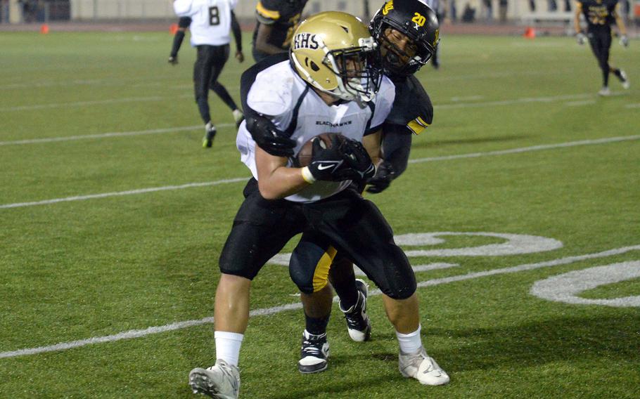 Humphreys' Koah Meno is corraled by Kadena's James Kinney after catching a pass.