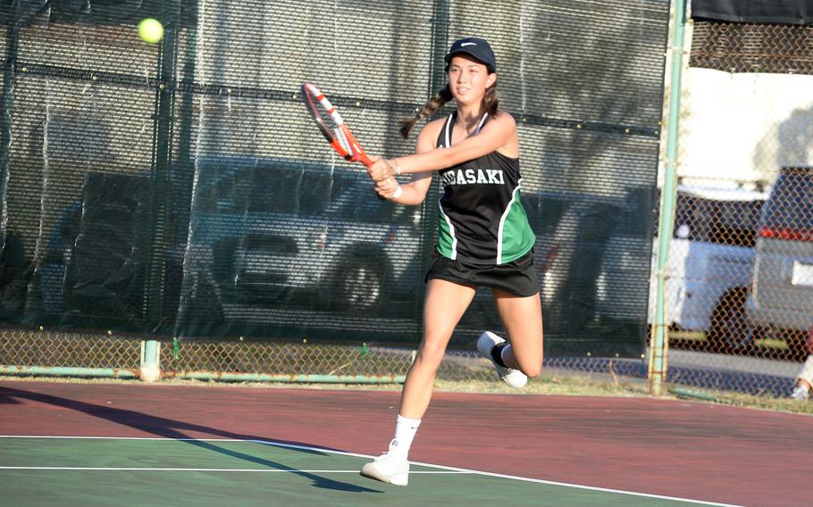 Kubasaki's Lan Legros smacks a backhand return.