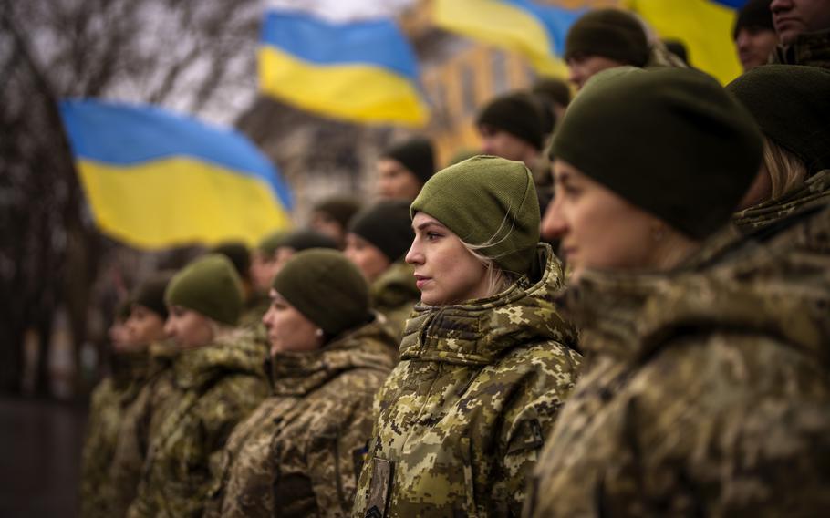 Ukrainian Army soldiers pose for a photo as they gather to celebrate a Day of Unity in Odessa, Ukraine, Wednesday, Feb. 16, 2022. As Western officials warned a Russian invasion could happen as early as today, the Ukrainian President Zelenskyy called for a Day of Unity, with Ukrainians encouraged to raise Ukrainian flags across the country.