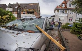 A damaged car is seen after a storm in Paderborn, Germany, Friday, May 20, 2022. (Lino Mirgeler/dpa via AP)