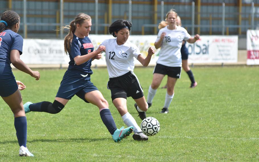 Vicenza's Kiera Mukai gets to the ball before Aviano's Kylee Moncur can arrive in the Cougars' 7-0 victory on Saturday, April 23, 2023.