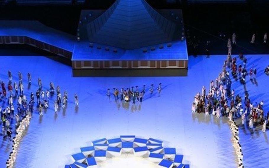 Performers, including Alice Stratton, daughter of an airman assigned to Yokota Air Base, make their way into the stadium during the Tokyo Olympics’ opening ceremony, July 23, 2021. 