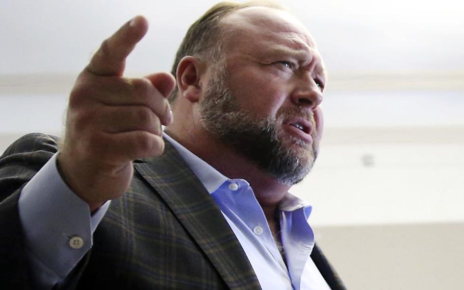 Alex Jones talks to media during a midday break in his trial at the Travis County Courthouse in Austin, Texas, on July 26, 2022. A six-member jury with several alternates in Connecticut will begin hearing evidence, Tuesday, Sept. 13, 2022, on how much Jones should pay the families, since he already has been found liable for damages to them. The trial is expected to last about four weeks.