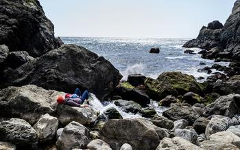 Since Highway 1 was closed by a landslide, Big Sur residents have been able to enjoy an empty Partington Cove Trail usually crowded with visitors. This sunbather enjoys the waves and wind April 6, 2024.