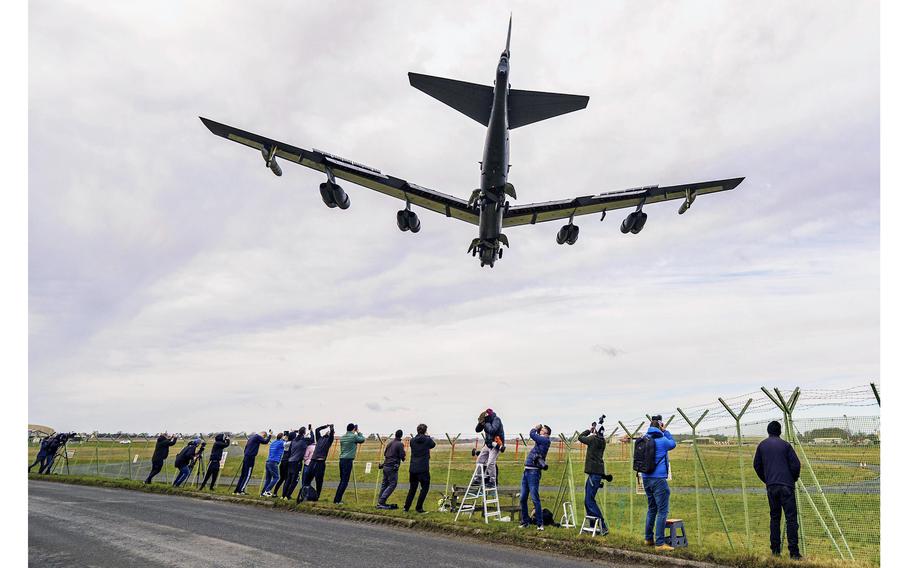 Photographers capture images of a United States Air Force B-52 bomber during landing at RAF Fairford, in Gloucestershire, England, Thursday, Feb. 10, 2022. 