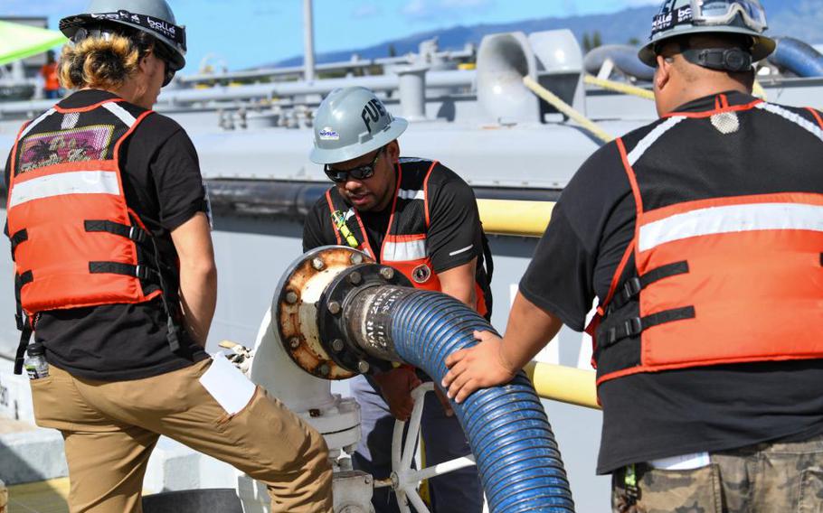 Fuel distribution system workers turn a valve to begin unpacking F76 marine diesel fuel onboard Joint Base Pearl Harbor-Hickam Hawaii, Oct. 27, 2022. Defense Secretary Lloyd Austin ordered the permanent defueling of the Red Hill tanks in March after months of efforts by the Navy to fight an emergency order from the state Department of Health calling on the Navy to empty the tanks.