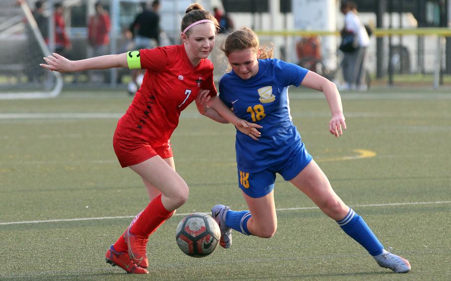 Nile C. Kinnick's Lucy Mock and Yokota's Hailey Riddels scuffle for the ball during Tuesday's DODEA-Japan/Kanto Plain girls soccer match. The Red Devils won 5-0 to remain unbeaten at 15-0.