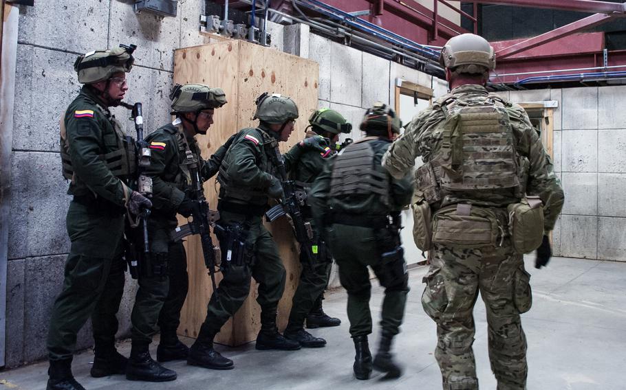 A U.S. Special Forces soldier observes elite Colombian troops during training at Eglin Air Force Base in Florida in 2015. The two militaries have a partnership dating back decades.