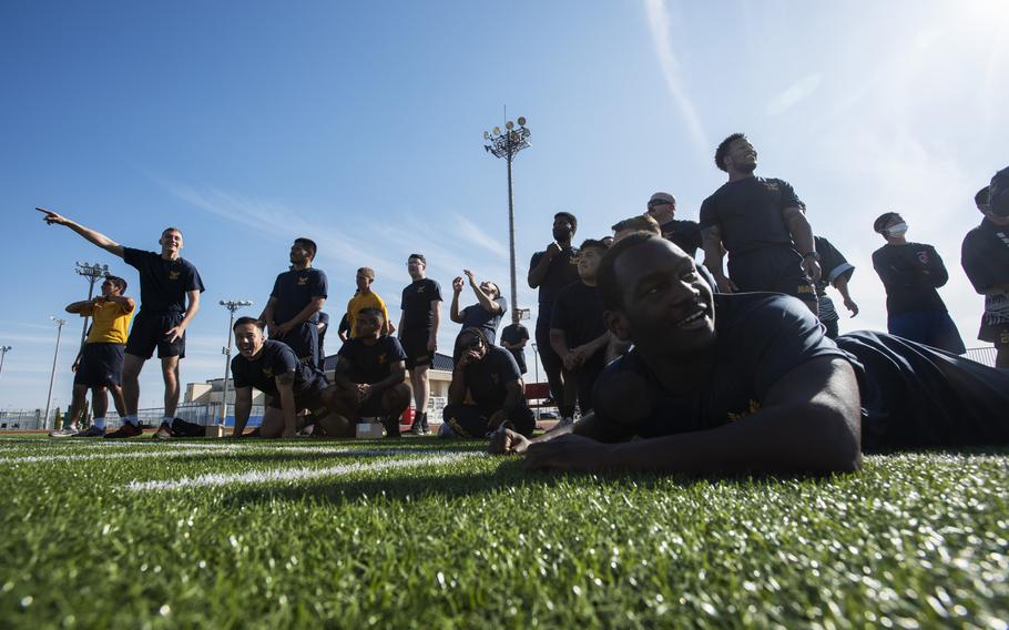 The Navy squad shouts support from the sidelines during Sports Day competition at Marine Corps Air Station Iwakuni, Japan, on Oct. 28, 2022.