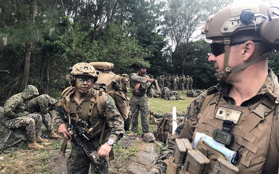 Lt. Col. Jason Copeland, right, commander of 3rd Battalion, 4th Marine Regiment, prepares to board a CH-53 Super Stallion at Camp Schwab, Okinawa, Feb. 14, 2023.