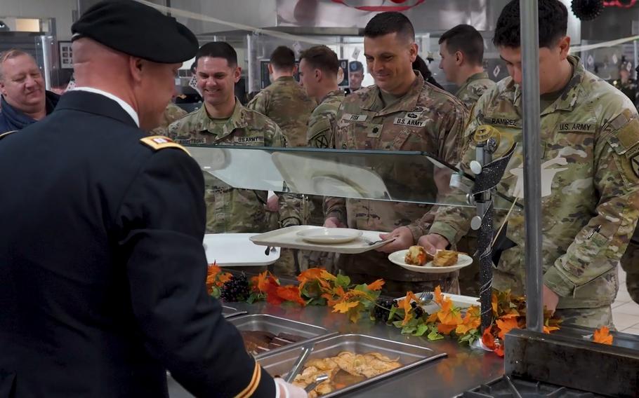 In this screenshot from video, soldiers from the 10th Mountain Division are served a Thanksgiving meal by the command team from the 1st Brigade Combat Team at the 1st BCT Dining Facility on Fort Drum, N.Y., Tuesday, Nov. 21, 2023.