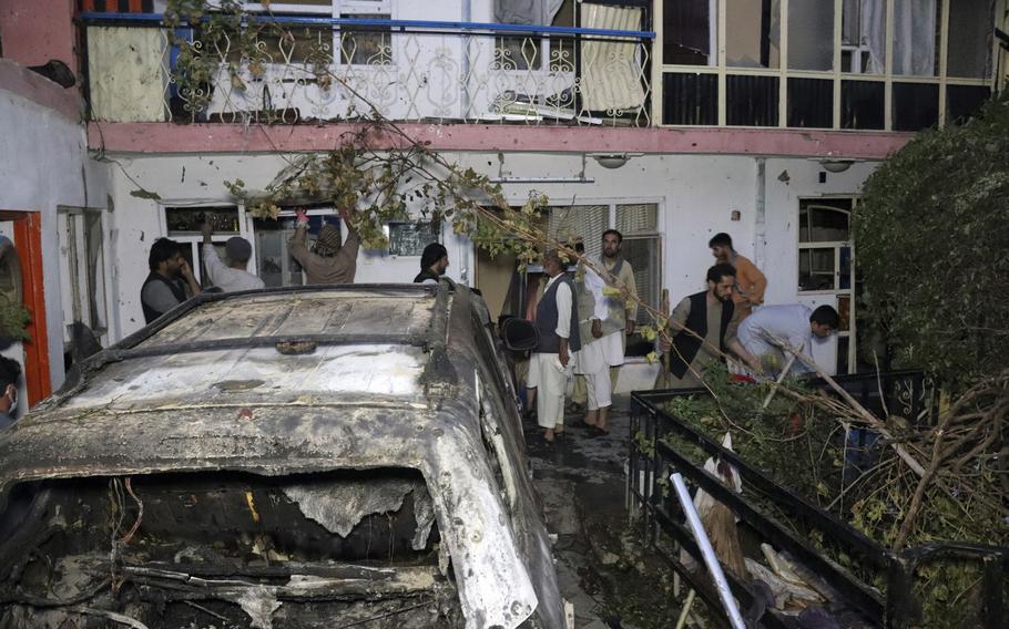 In this Sunday, Aug. 29, 2021 file photo, Afghans inspect damage of Ahmadi family house after U.S. drone strike in Kabul, Afghanistan. The strike killed 10 civilians, including seven children.
