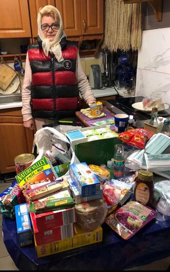 A woman in Rivne, Ukraine, stands by donations collected by volunteers in the Kaiserslautern military community in Germany for women and children in Ukraine on Thursday, March 10, 2022. Donations were loaded onto a truck on Saturday and are being distributed in various parts of war-torn Ukraine this week.