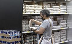 A shopper checks a carton of eggs inside a grocery store in San Francisco on May 2, 2022. MUST CREDIT: Bloomberg photo by David Paul Morris.