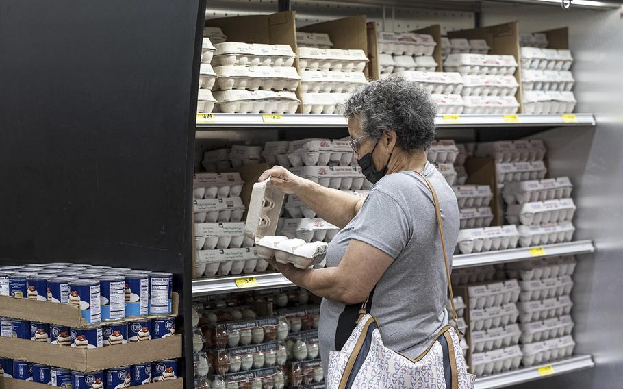 A shopper checks a carton of eggs inside a grocery store in San Francisco on May 2, 2022. 