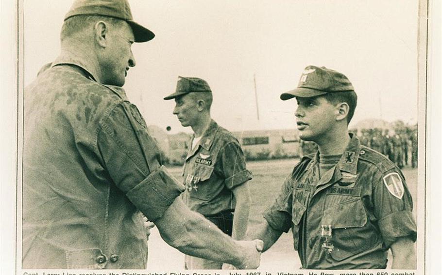 Capt. Larry Liss receives the Distinguished Flying Cross for his heroics in a May 14, 1967, rescue operation in Vietnam. Decades later, there is an effort underway to have his medal upgraded.