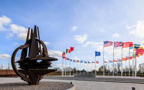 NATO countries’ flags fly at alliance headquarters in Brussels.