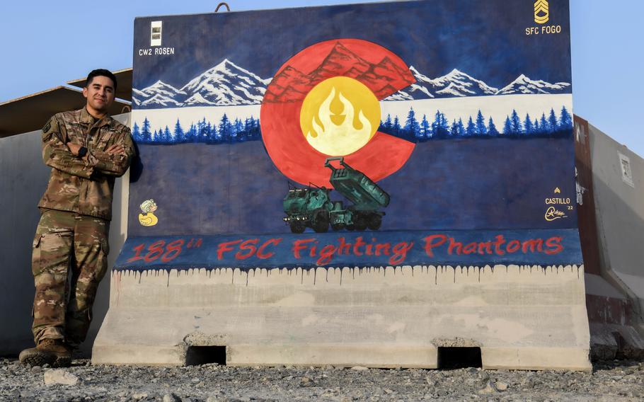 U.S. Army Sgt. Anthony Castillo, a mobility specialist assigned to the 3-157th Field Artillery unit and Colorado National Guard, stands beside a mural he painted for the 188th Fighting Support Company, Sept. 17, 2022, at Al Dhafra Air Base, United Arab Emirates.