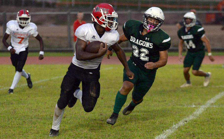 Nile C. Kinnick's Wendell Harrison tries to elude Kubasaki's Justin Podzon around right end.