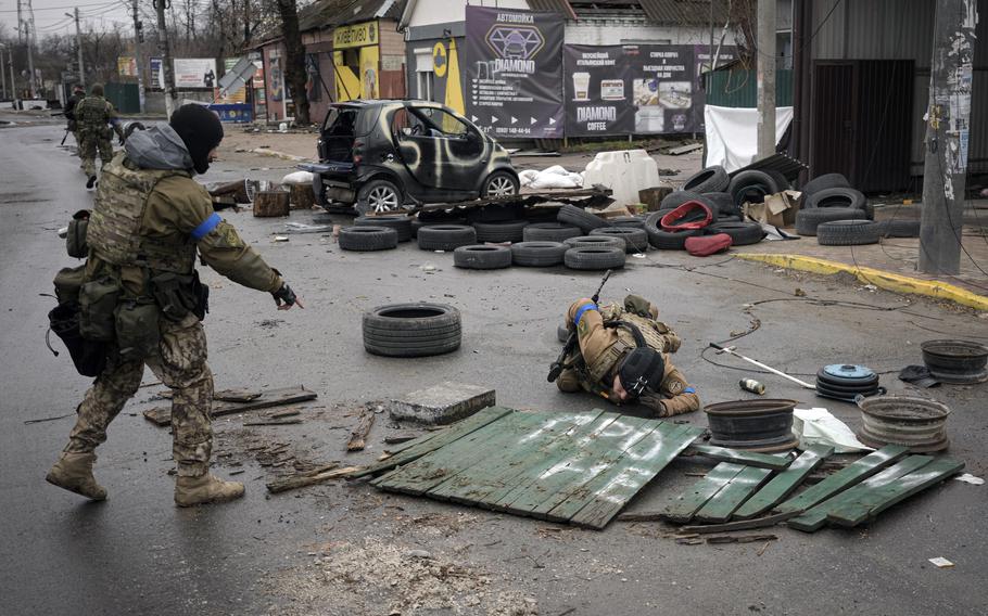 Ukrainian servicemen check streets for booby traps in the formerly Russian-occupied Kyiv suburb of Bucha, Ukraine, Saturday, April 2, 2022. As Russian forces pull back from Ukraine's capital region, retreating troops are creating a "catastrophic" situation for civilians by leaving mines around homes, abandoned equipment and "even the bodies of those killed," President Volodymyr Zelenskyy warned Saturday.