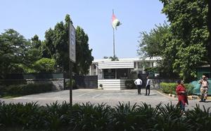 People stand outside the Afghan Embassy in New Delhi, India, Friday, Sept. 29, 2023. India's External Affairs Ministry is examining a letter from the Afghan Embassy that says it plans to cease all operations in the Indian capital by Saturday, an official said Friday. India has not recognized the Taliban government which seized power in Afghanistan in August 2021. It evacuated its own staff from Kabul ahead of the U.S. withdrawal from Afghanistan two years ago and no longer has a diplomatic presence there. (AP Photo)