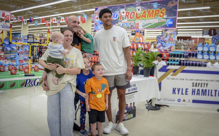 Baltimore Ravens strong safety Kyle Hamilton poses with fans in the commissary at Camp Humphreys, South Korea, April 12, 2024.