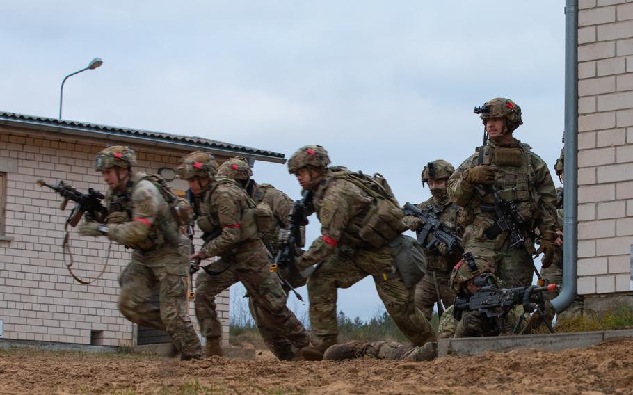 U.S. Army soldiers with Charlie Company, 3rd Battalion, 67th Armored Regiment, 2nd Armored Brigade Combat Team, 3rd Infantry Division, execute tactical movement on urbanized terrain during the Strong Griffin exercise at Pabrade Training Area, Lithuania, Nov. 17, 2023.