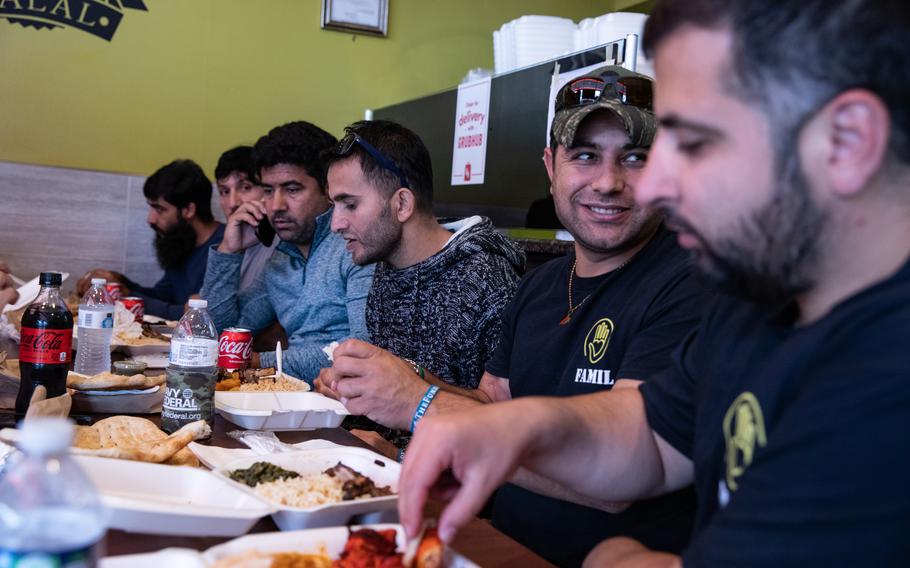 Former Zero Unit soldiers from Afghanistan gather for an Afghan meal with FAMIL staff.