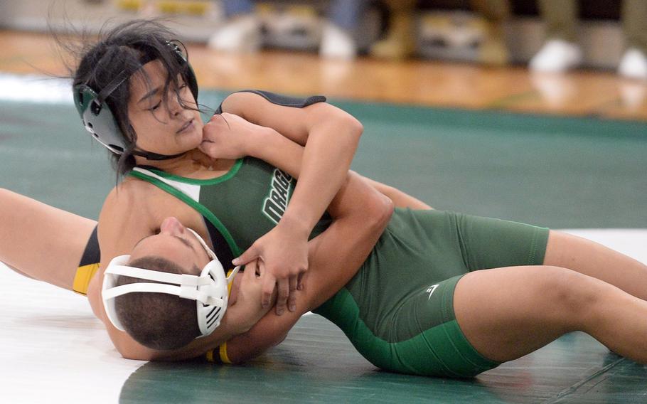 Kubasaki's Gwen Panteleone locks in a head-and-arm hold on Kadena's Jayden Green at 101 pounds pounds during Wednesday's Okinawa wrestling dual meet. Panteleone pinned Green in 4 minutes, 37 seconds, but the Panthers won the meet 30-27.