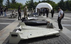 Visitors check damaged Russian drones during the International Conference on Expanding Sanctions Against Russia in Kyiv, Ukraine, Friday, June 27, 2025. (AP Photo/Efrem Lukatsky)