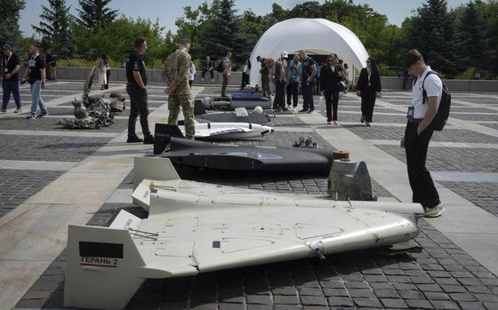 Visitors check damaged Russian drones during the International Conference on Expanding Sanctions Against Russia in Kyiv, Ukraine, Friday, June 27, 2025. (AP Photo/Efrem Lukatsky)
