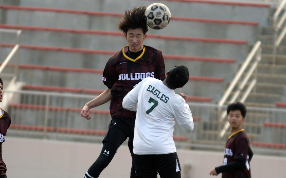 Marist's Kaito Izumi goes up to head the ball against Robert D. Edgren during Saturday's Perry Cup quarterfinal. The Bulldogs won 4-1 and went on to win the championship.