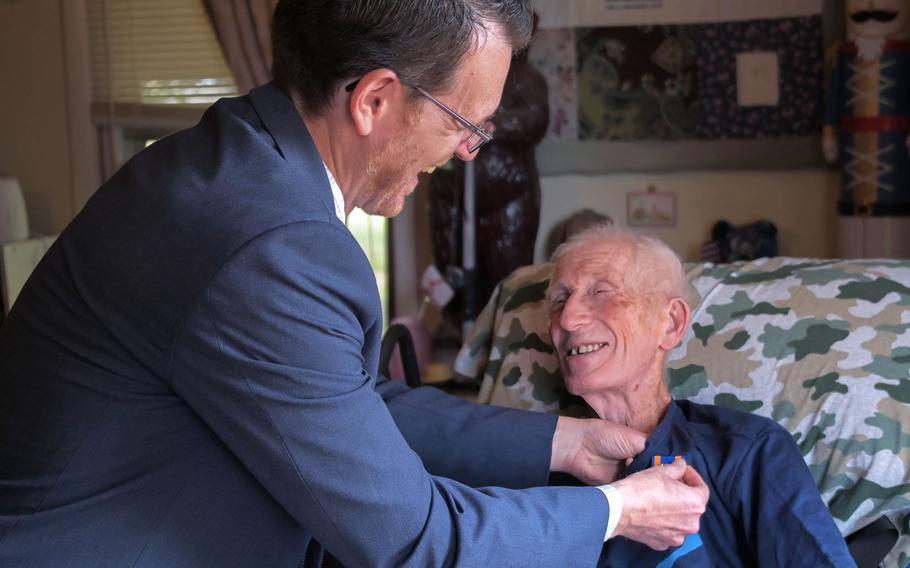 Maryland Del. Justin Ready, (R-5A, Carroll County) pins the Air Medal on the shirt of George Keeney, who served in the Vietnam War and is now in hospice care at his home in New Windsor, Md., on June 19, 2023.