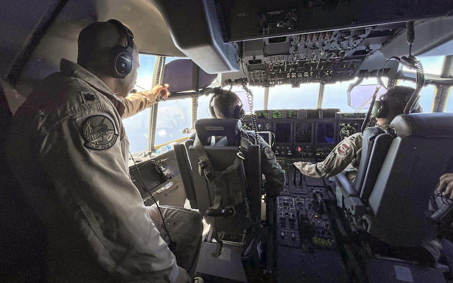 Lt. Col. Jeremy Anderson, left, guides the crew of a U.S. Air Force C-130 cargo plane during an airdrop of humanitarian aid into northern Gaza on Wednesday, March 20, 2024. Anderson, airborne mission commander on the flight, has gone on five airdrop missions since the beginning of March.