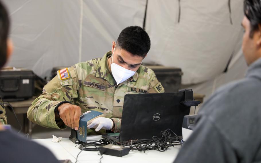 Spc. Alejandro Haro, military police, Task Force Ever Vigilant, checks-in evacuees on Camp Bondsteel, Kosovo, Sept. 20, 2021.