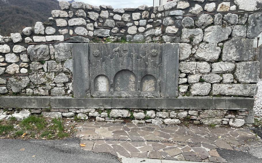 A coat of arms adorns a fortification near the entrance to Venzone, Italy. The walled medieval town in the northeastern part of the country is a UNESCO World Heritage site.