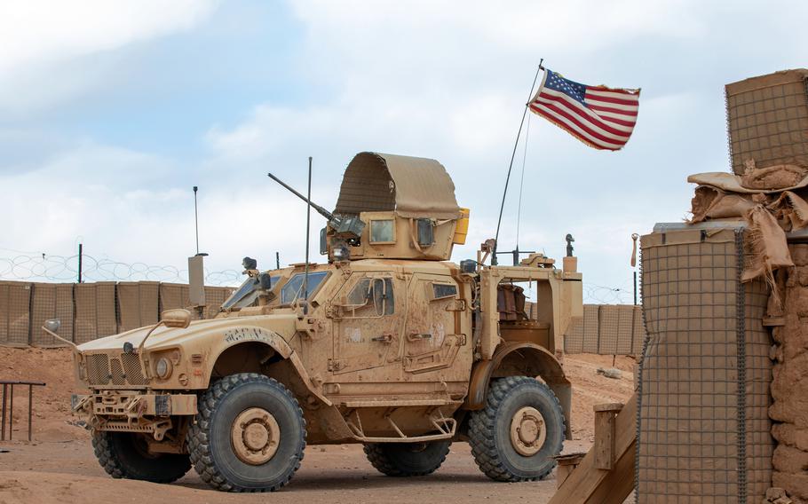 A U.S. Army joint light tactical vehicle, flying an American flag, patrols in Syria.