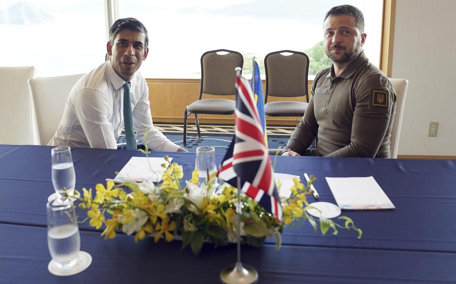 Britain’s Prime Minister Rishi Sunak, left, and Ukraine President Volodymyr Zelenskyy meet at the Grand Prince Hotel, during the G7 Summit in Hiroshima, Japan, Saturday, May 20, 2023. 