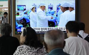 A TV screen shows a file image of North Korean leader Kim Jong Un, third from left, during a news program at the Seoul Railway Station in Seoul, South Korea, Monday, May 29, 2023. Japan's coast guard said North Korea has notified it that it plans to launch a satellite in coming days. (AP Photo/Ahn Young-joon)