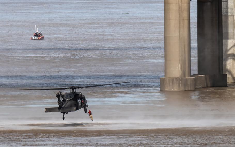 A pararescueman from the Kentucky Air National Guard’s 123rd Special Tactics Squadron leaps into the Ohio River from a Kentucky Army National Guard UH-60 Black Hawk as part of a helocast water-rescue demonstration during the Thunder Over Louisville air show in Louisville, Ky., Saturday, April 20, 2024.