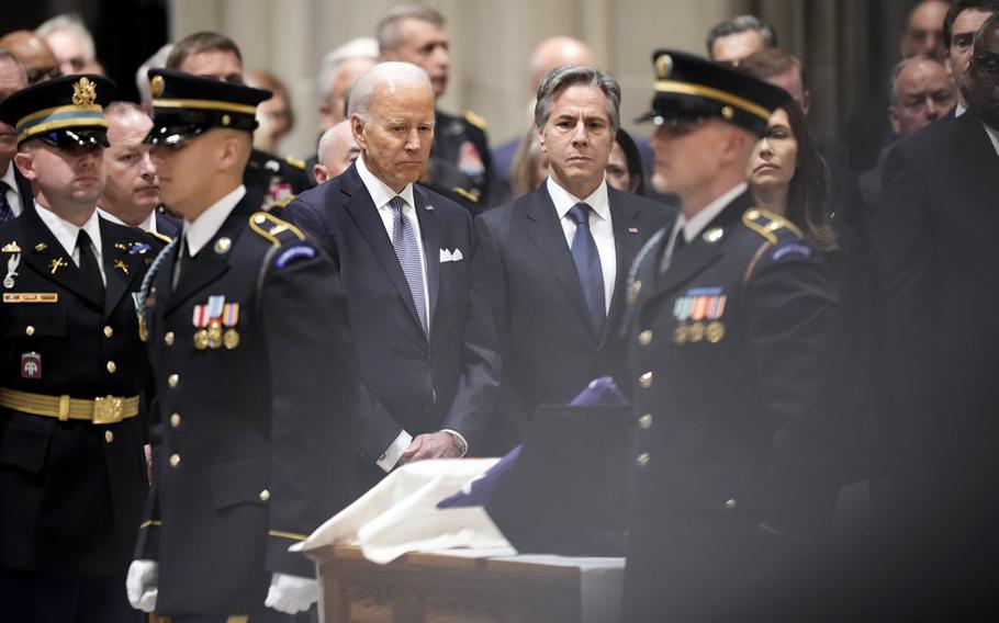 President Joe Biden and Secretary of State Antony Blinken look toward the urn with the cremated remains of former Defense Secretary Ash Carter during a memorial service for Carter at the National Cathedral in Washington on Thursday, Jan. 12, 2023.
