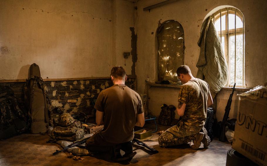 Ukrainian snipers load their rifles ahead of an operation in Maryinka on May 16. MUST CREDIT: Photo for The Washington Post by Wojciech Grzedzinski.