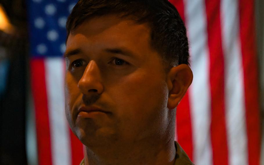 Sgt. 1st Class Nathan Phelps, military police officer, CJTF-HOA, from Locke, N.Y., takes the Oath of Enlistment while aboard a KC-130J over East Africa, Sept. 11, 2021. 