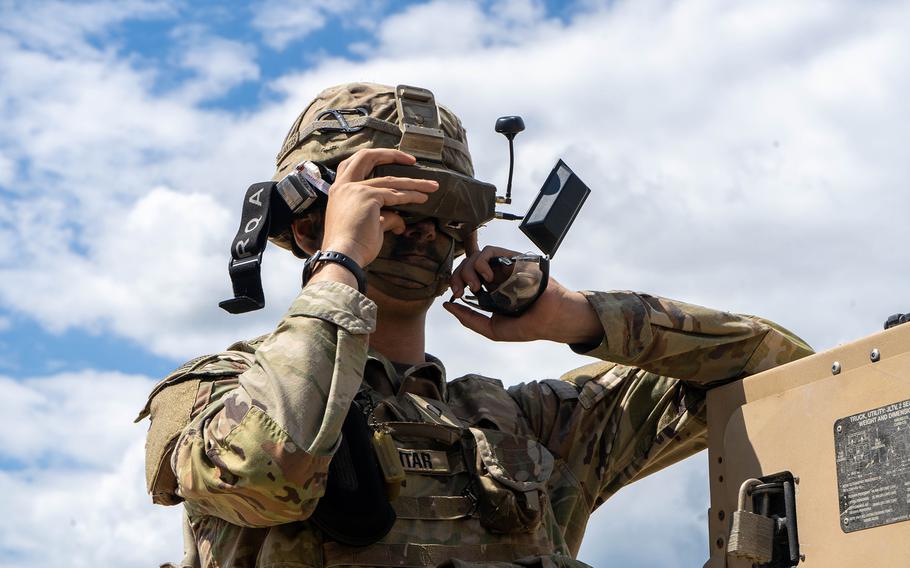 A soldier looks through his goggles to pilot a drone.